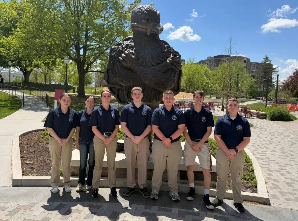Roanoke County cadets gathered in front of the Virginia Tech HokieBird statue